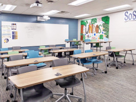 Furnished classroom with Steelcase Verb tables and whiteboards.